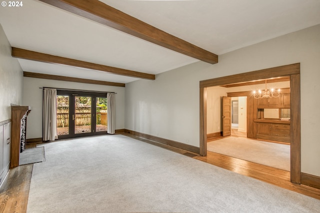 unfurnished living room featuring hardwood / wood-style floors, beamed ceiling, and a chandelier