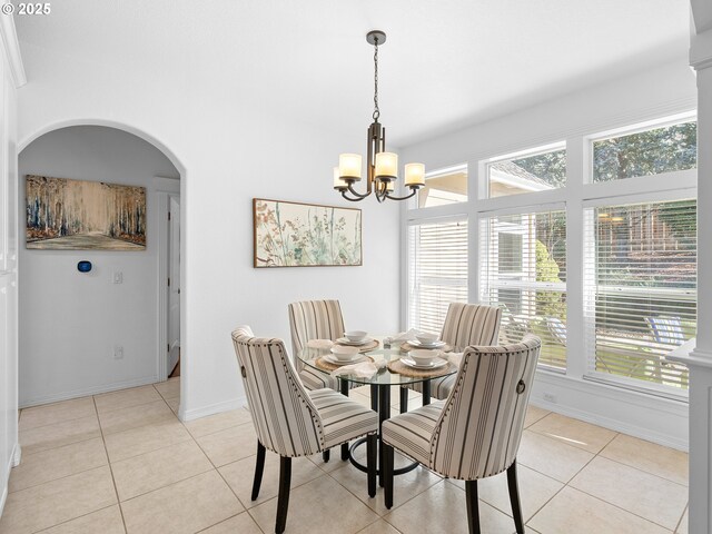 kitchen featuring ornamental molding, sink, light tile patterned floors, an inviting chandelier, and white cabinets