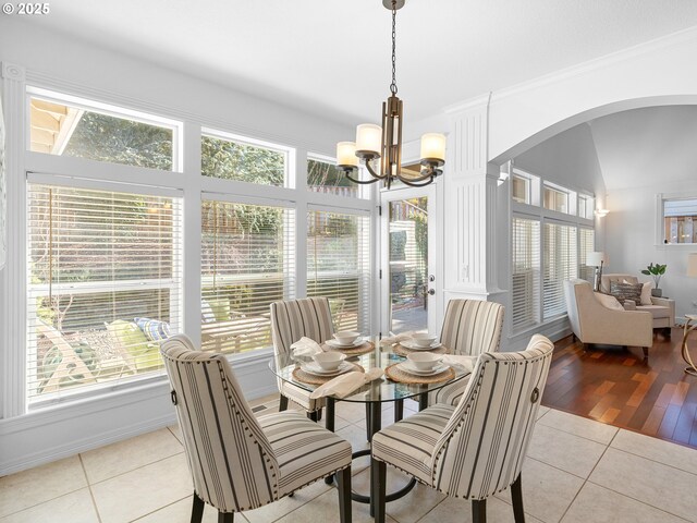 kitchen featuring appliances with stainless steel finishes, decorative columns, sink, white cabinets, and light tile patterned flooring