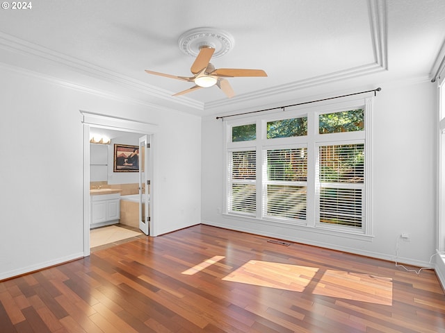 spare room with ceiling fan, ornamental molding, a textured ceiling, and light wood-type flooring