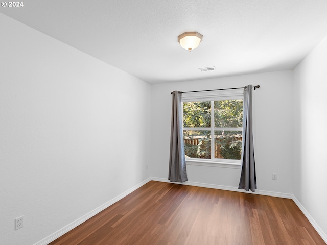 empty room featuring hardwood / wood-style flooring