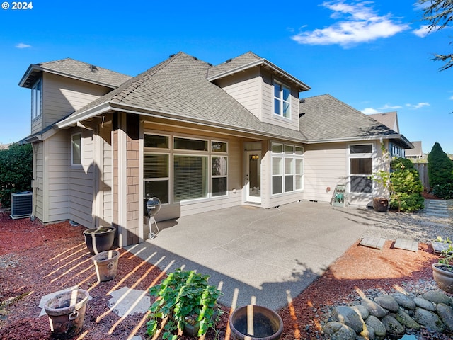 rear view of property featuring central AC and a patio area