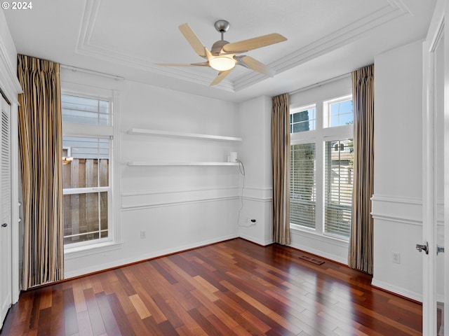 spare room with dark hardwood / wood-style flooring, ceiling fan, and crown molding