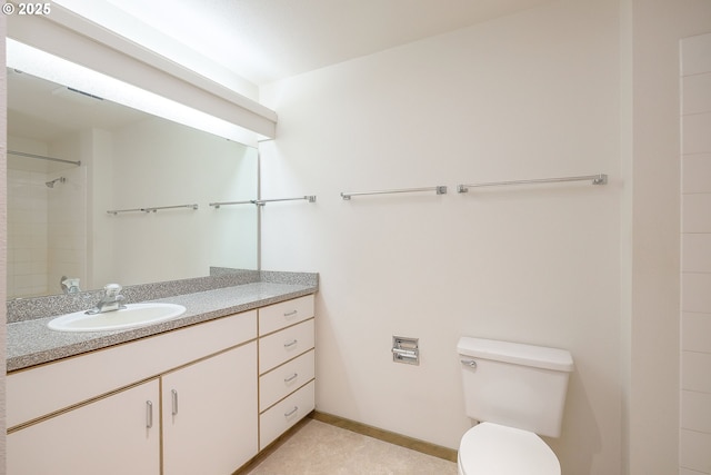 bathroom with vanity, toilet, and a shower