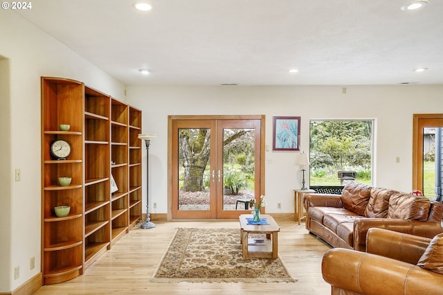 living room featuring french doors and light hardwood / wood-style floors