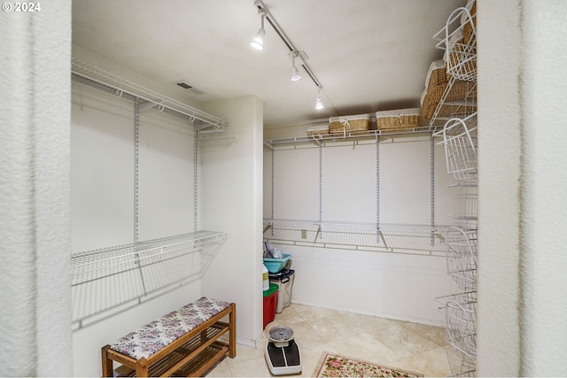 spacious closet with light tile floors