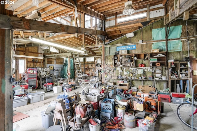 miscellaneous room with concrete floors and a workshop area