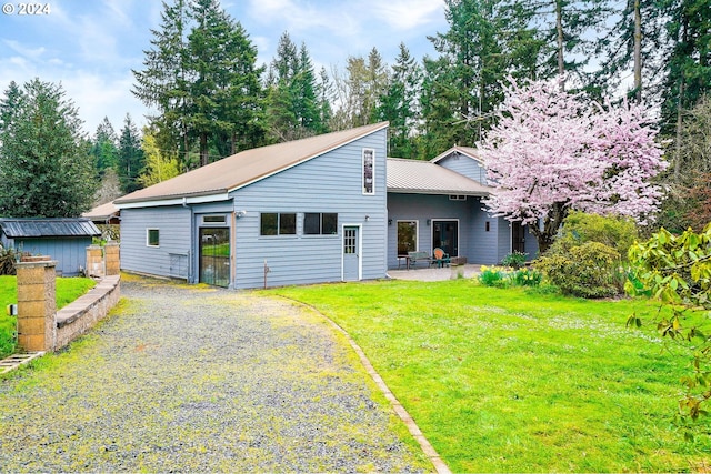 view of front of property featuring a front lawn and a patio