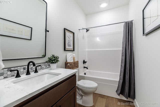 full bathroom with shower / bath combination with curtain, toilet, vanity, and hardwood / wood-style flooring