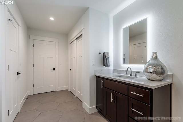 bathroom with tile flooring and vanity