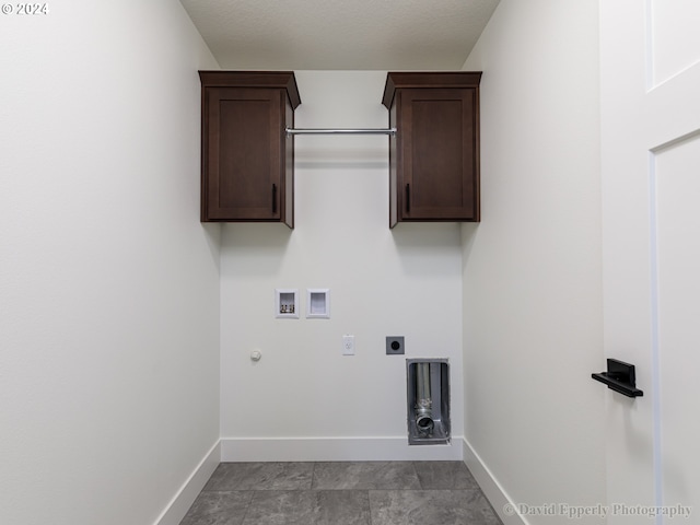 laundry area with light tile flooring, hookup for a gas dryer, cabinets, hookup for an electric dryer, and hookup for a washing machine