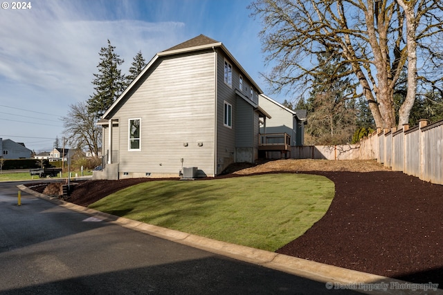 view of home's exterior with central AC unit and a yard