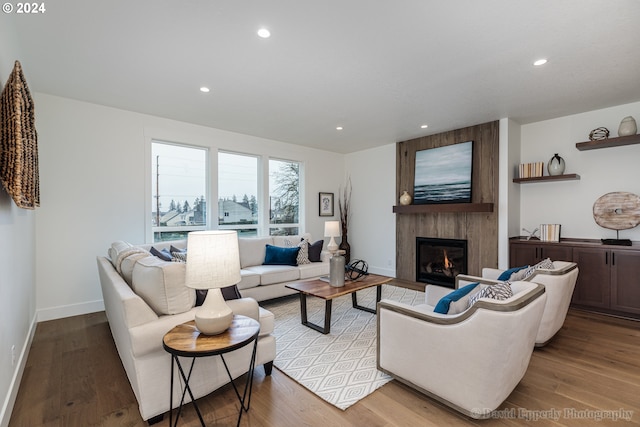 living room with light hardwood / wood-style flooring and a fireplace