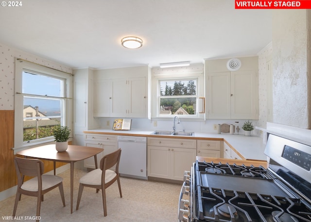 kitchen with stainless steel range with gas stovetop, sink, dishwasher, and white cabinetry