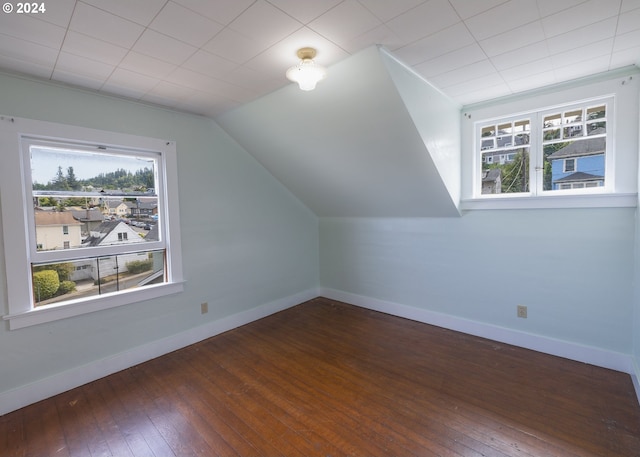 additional living space with lofted ceiling and dark hardwood / wood-style flooring