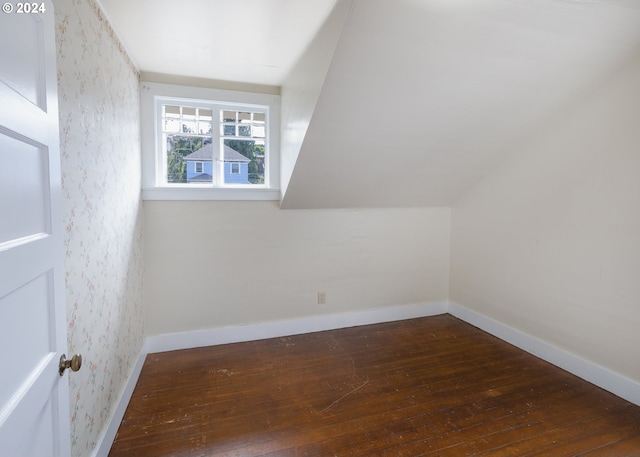 additional living space with lofted ceiling and dark hardwood / wood-style flooring