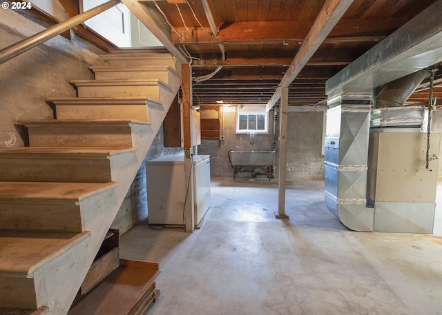 basement featuring heating unit and fridge