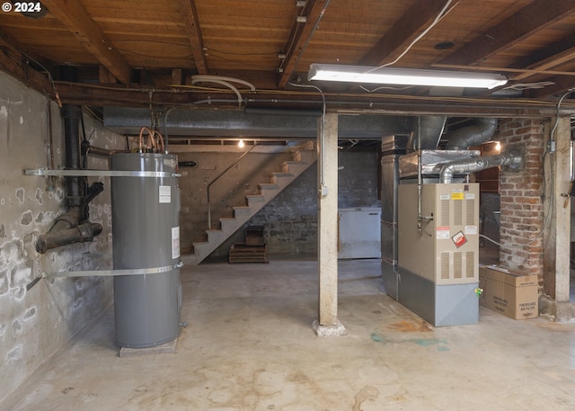 basement featuring strapped water heater and heating unit