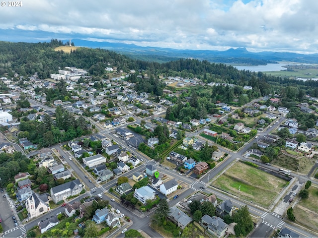 birds eye view of property with a water and mountain view