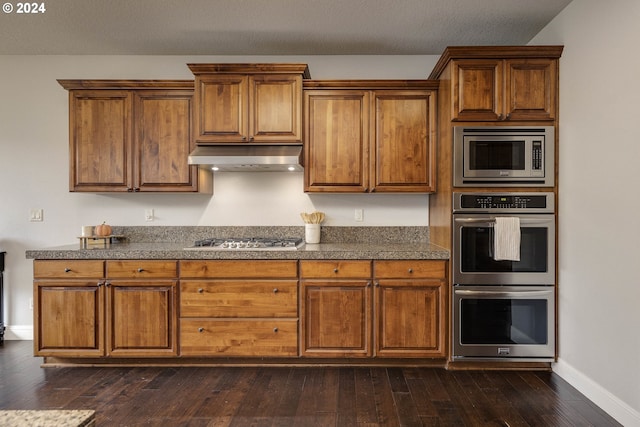 kitchen with stainless steel appliances and dark wood-type flooring