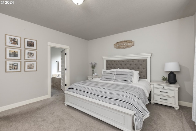 bedroom with light colored carpet and ensuite bathroom