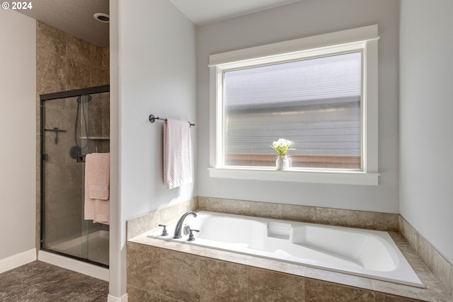 bathroom with shower with separate bathtub and tile patterned floors