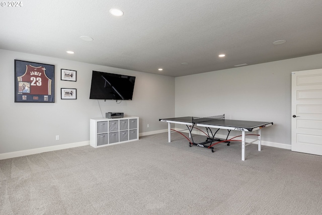 playroom with a textured ceiling and carpet floors