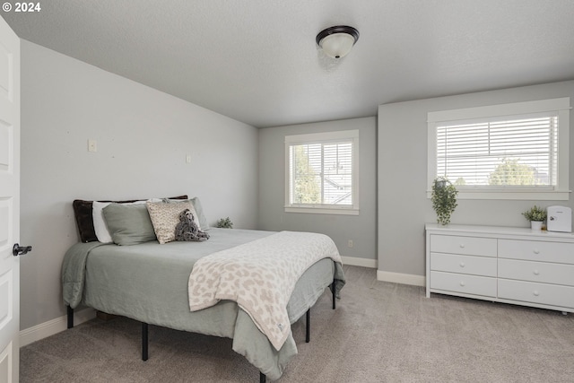 carpeted bedroom with a textured ceiling