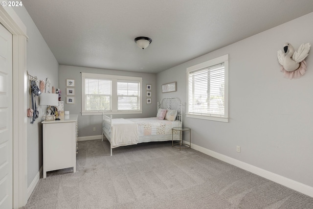 carpeted bedroom featuring multiple windows