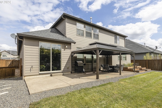 back of property featuring a gazebo, a patio, and a yard