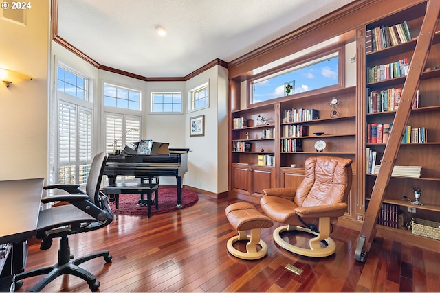 office area with wood-type flooring, a healthy amount of sunlight, and crown molding