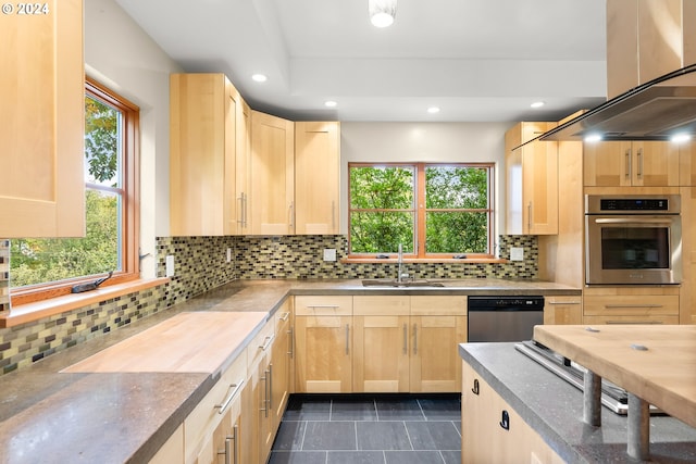 kitchen featuring light brown cabinetry, island range hood, appliances with stainless steel finishes, and tasteful backsplash