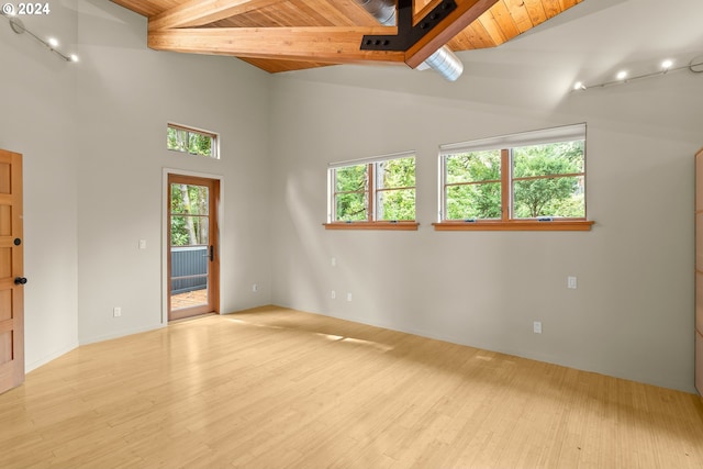 unfurnished room with wood ceiling, beamed ceiling, high vaulted ceiling, and light wood-type flooring