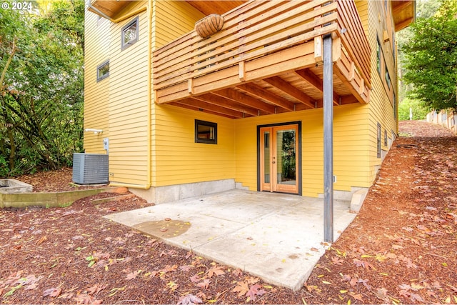 doorway to property featuring a patio and central AC unit