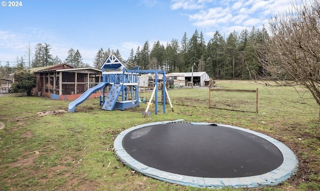 view of play area with a lawn and a trampoline