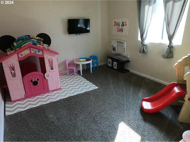 playroom with a wall unit AC and carpet