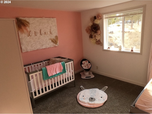 bedroom featuring a nursery area and carpet