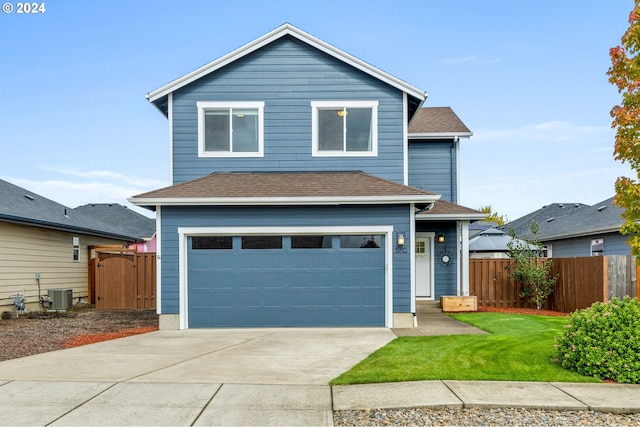 front facade featuring cooling unit, a front yard, and a garage