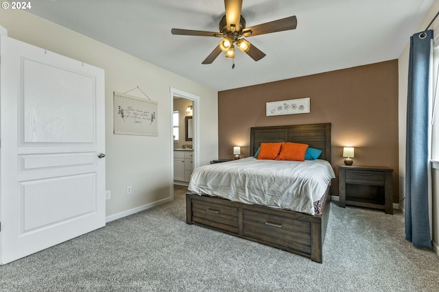 bedroom featuring ensuite bathroom, carpet flooring, and ceiling fan