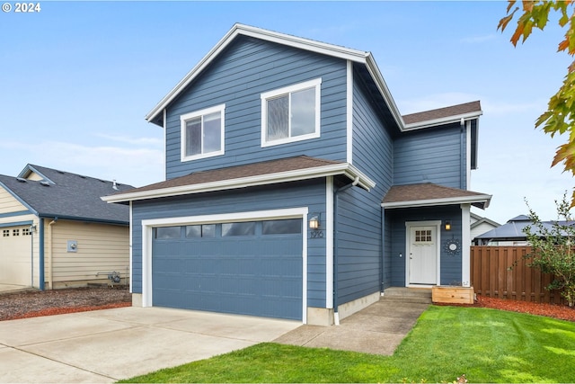 front of property featuring a front yard and a garage