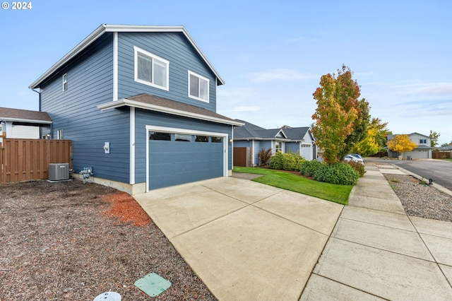 front of property featuring cooling unit and a garage