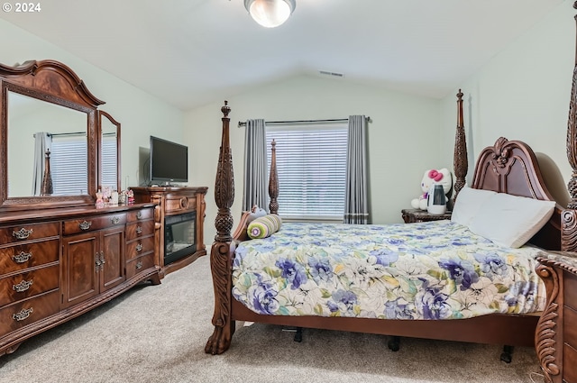 carpeted bedroom with lofted ceiling