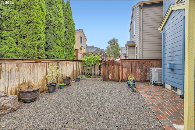 view of yard featuring central AC unit and a patio