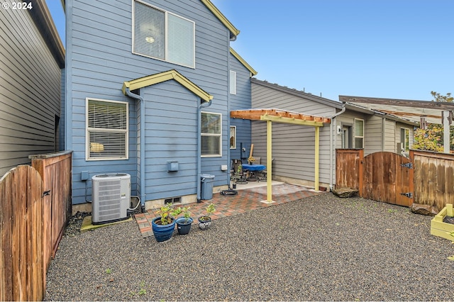 back of property featuring central AC unit and a patio