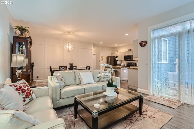 living room featuring light hardwood / wood-style floors and a chandelier