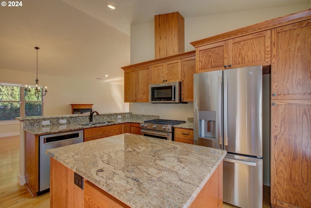 kitchen with appliances with stainless steel finishes, light wood-type flooring, vaulted ceiling, sink, and a chandelier