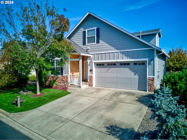 view of front of house with a front yard and a garage