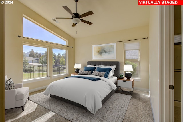 carpeted bedroom with vaulted ceiling and ceiling fan