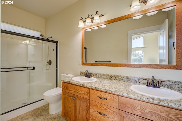 bathroom with tile patterned flooring, vanity, an enclosed shower, and toilet