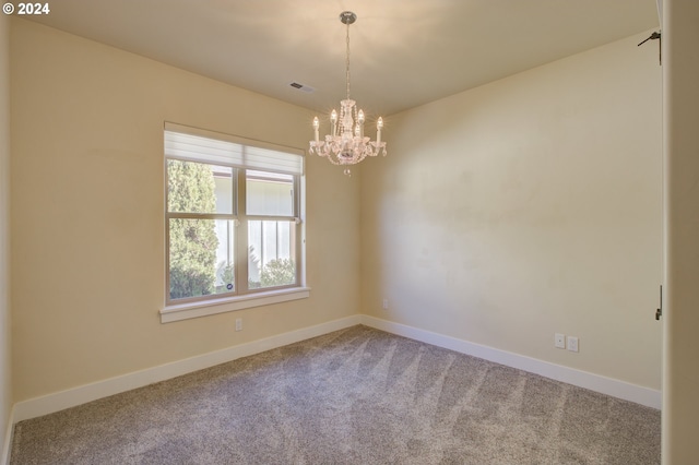 unfurnished room with carpet flooring and a chandelier